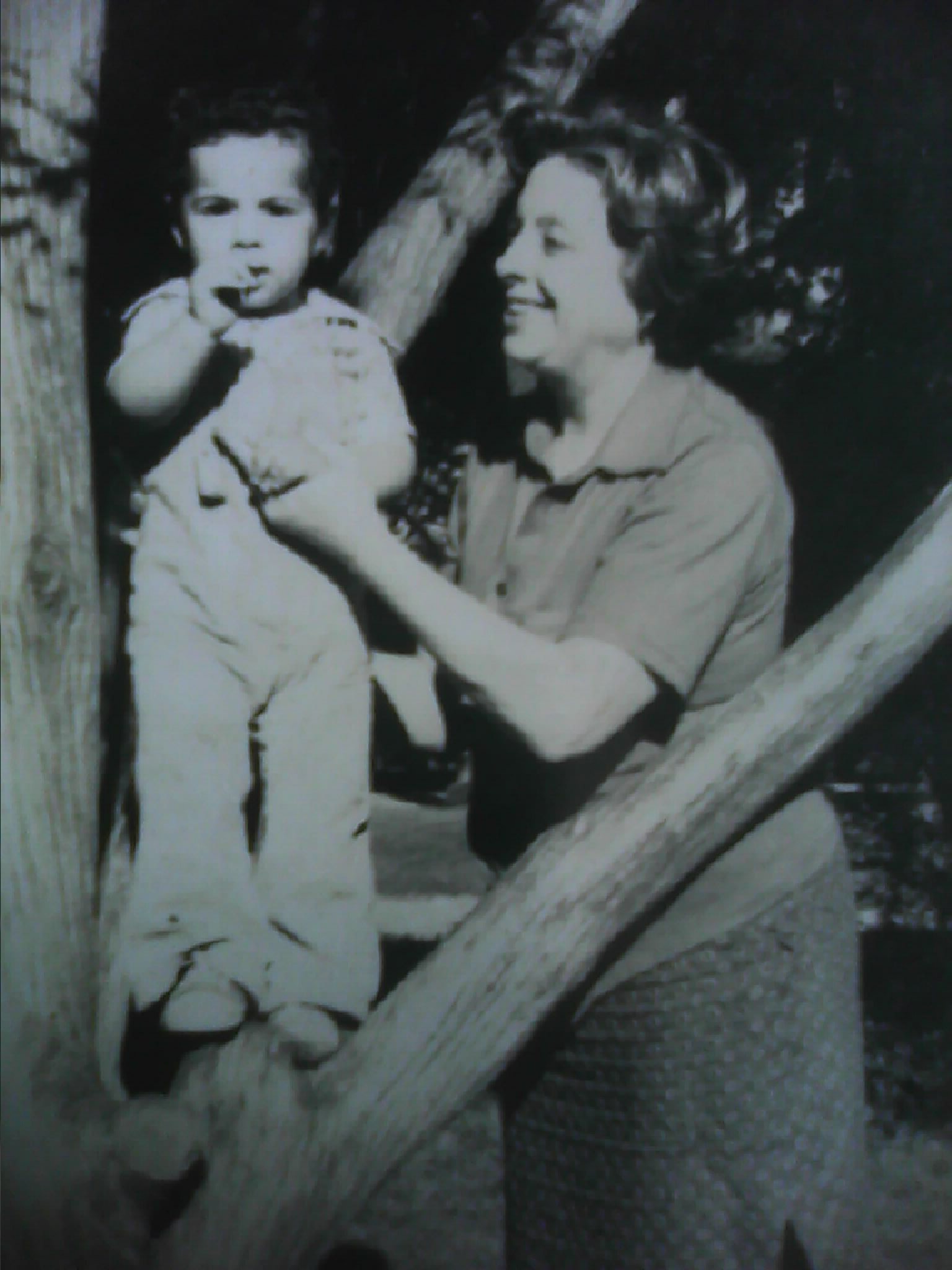 Marisa Bay with her grandson Louis Hannibal Nez beside a tree